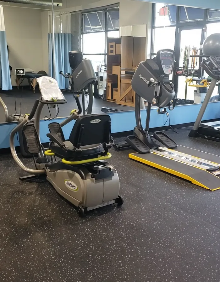 Cardio and strength equipment beside the private treatment bays at Maxicare