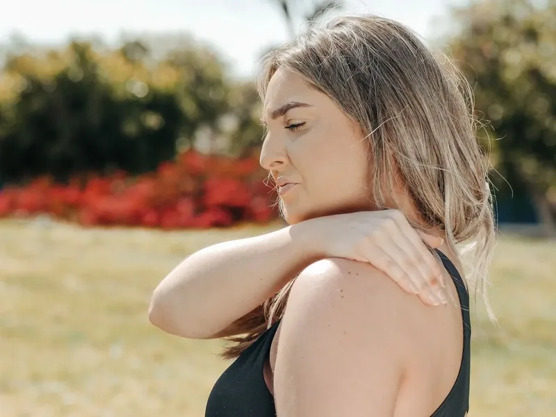 A person holding a sore knee