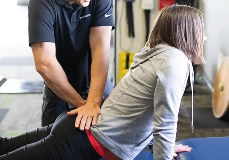 A therapist using hands-on manual therapy on a patient&rsquo;s back