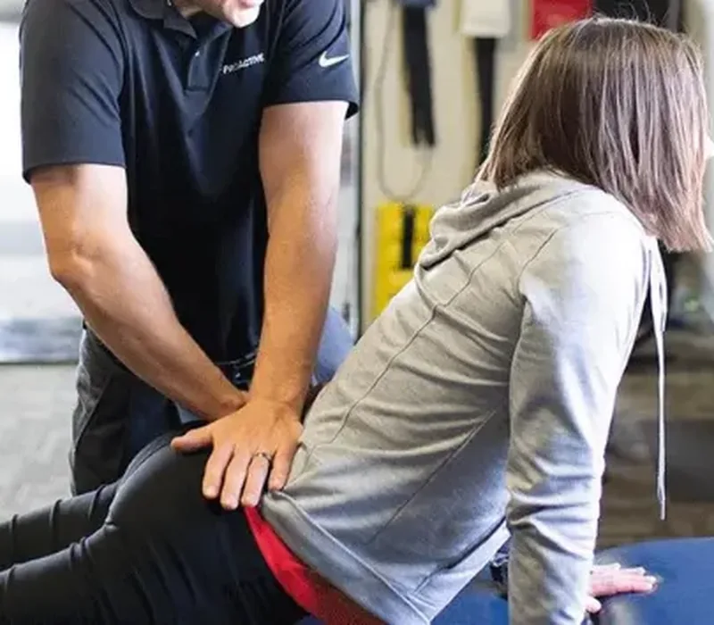 A therapist using hands-on manual therapy on a patient&rsquo;s back
